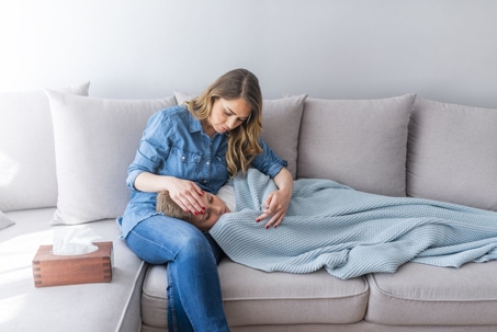 woman mother comforting her child who is sick